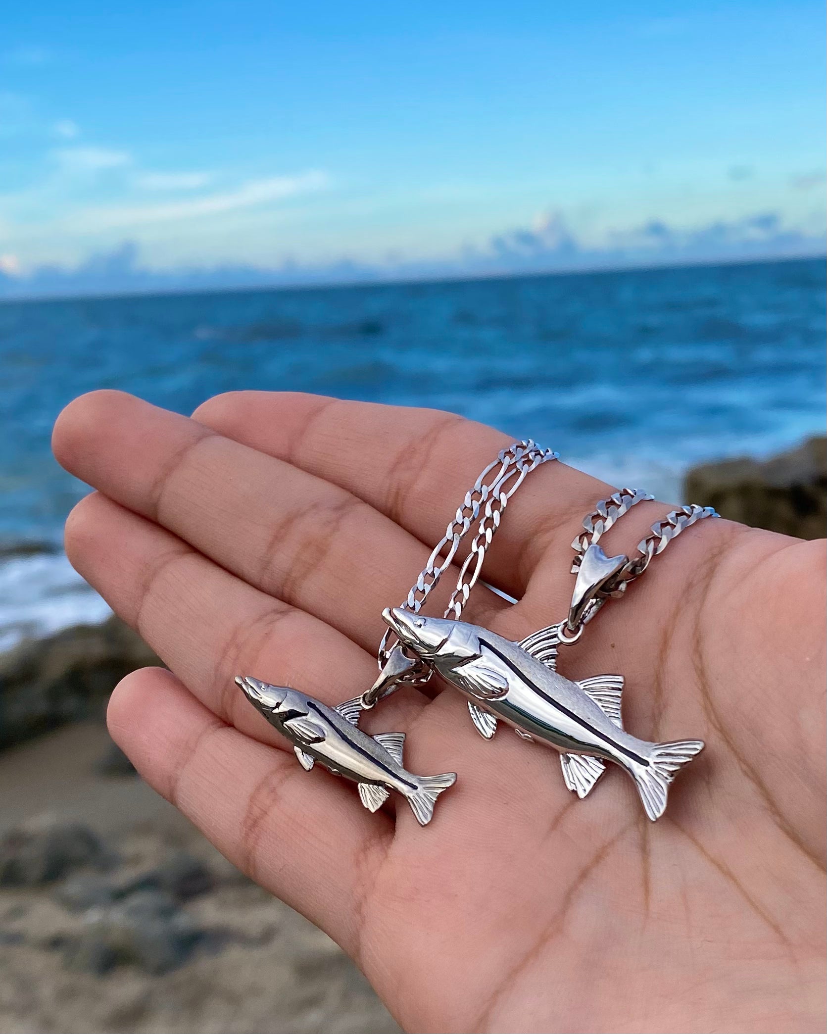 small and standard sized silver snook necklaces by castil