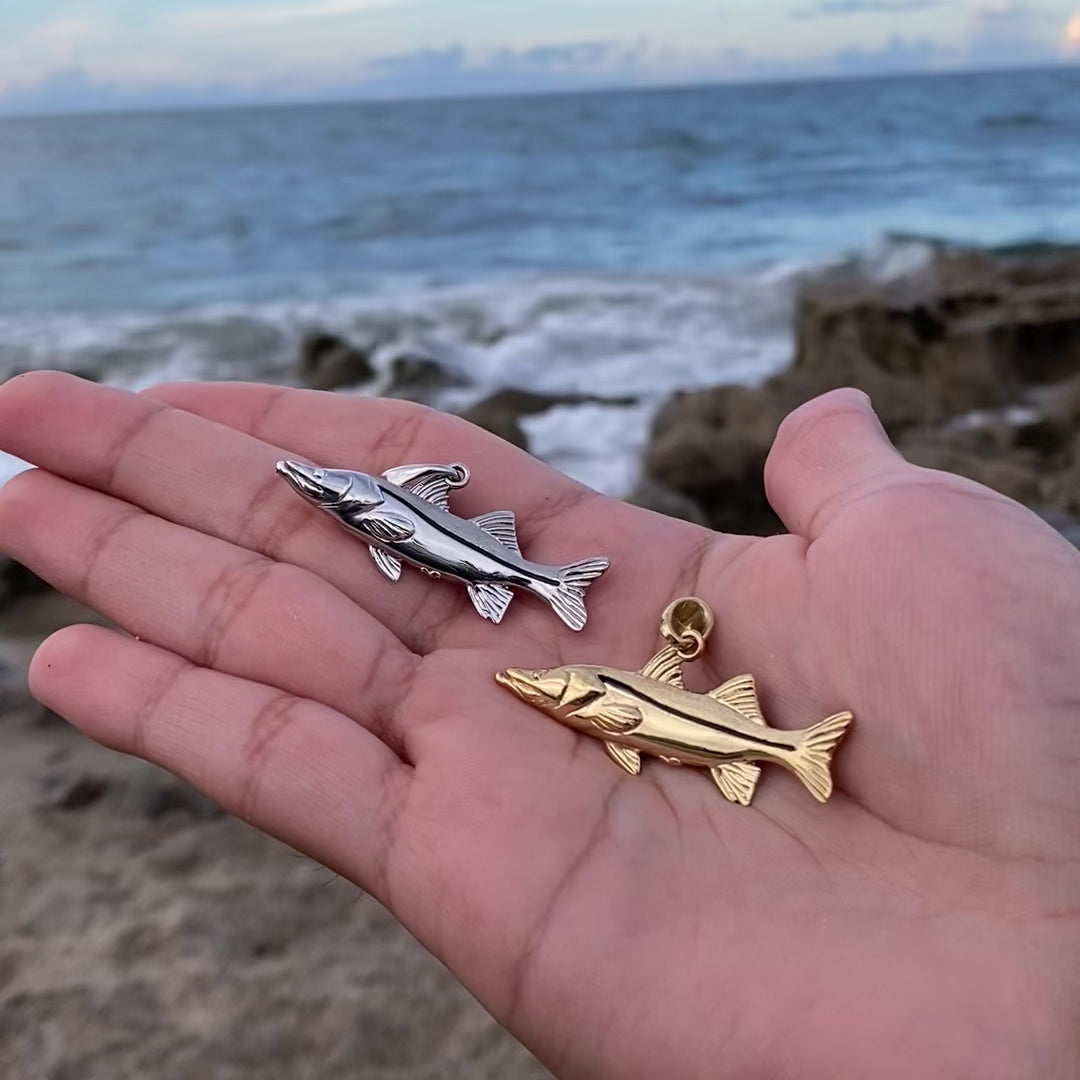 silver and gold snook pendants by castil
