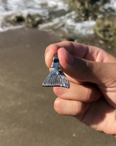 Video highlighting all of the details of the redfish tail pendant by Castil. Includes a black dot reminiscent of an actual black dot on a redfish tail, made out of black epoxy.