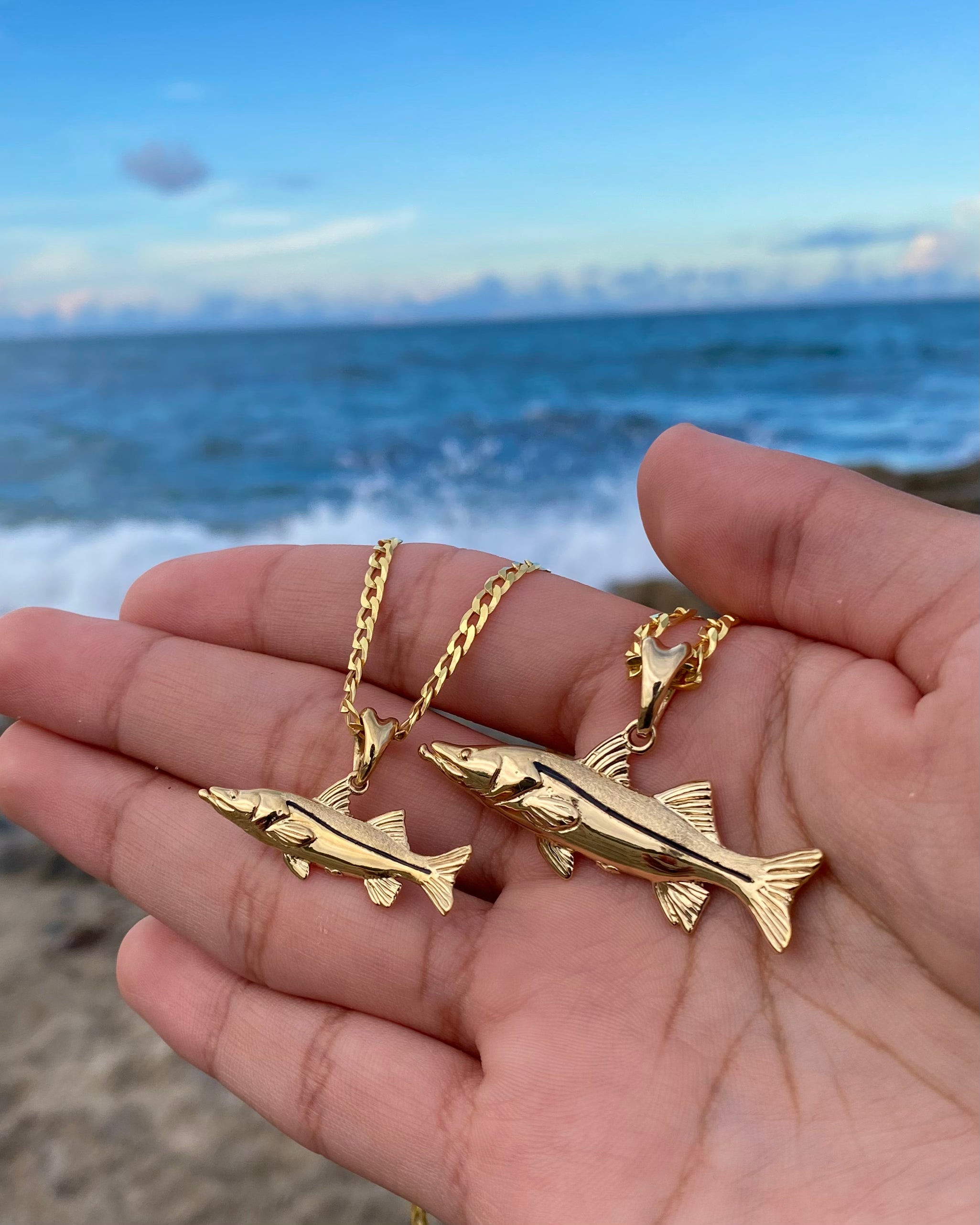 small and standard sized gold snook necklaces by castil